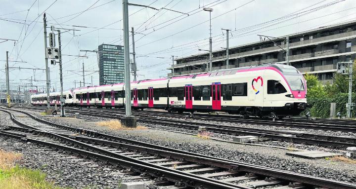 Eine Zuger Stadtbahn-Doppeltraktion auf dem Weg nach Baar. Sie passiert soeben den Nordkopf des Zuger Bahnhofs.